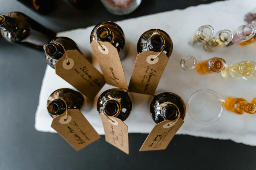 Top view of labeled brown bottles of essential oils on a white surface, perfect for aromatherapy.